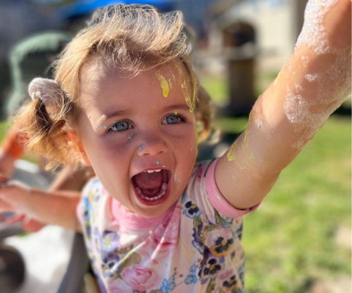child covered in paint and soap yelling
